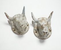 A pair of cast iron ‘bulls head’ mounts, 13.5cm