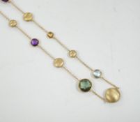 A modern Italian 9ct gold pebble and graduated multi gem set necklace, 68cm, gross weight 16 grams.