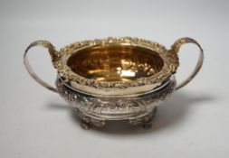 A George IV embossed silver two handled sugar bowl, Thomas James, London, 1822, diameter 14.7cm,