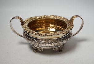 A George IV embossed silver two handled sugar bowl, Thomas James, London, 1822, diameter 14.7cm,