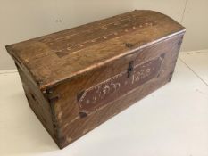A 19th century pine domed top trunk with painted simulated grain initialled “I.P.D” and dated
