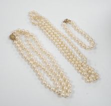 A single strand cultured pearl necklace, with diamond chip set 18ct gold clasp, 74cm and similar