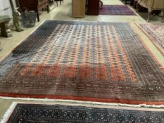 A Bokhara peach ground carpet, 364 x 275cm