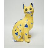 A Gallé yellow glazed model cat with glass eyes, signed E. Gallé, Nancy, 32cm high