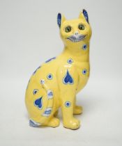 A Gallé yellow glazed model cat with glass eyes, signed E. Gallé, Nancy, 32cm high