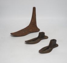 Six cast iron cobbler's forms and a door stop