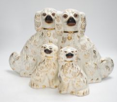 Two pairs of Victorian Staffordshire chimney spaniel dogs, largest 29cm high