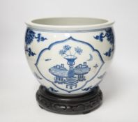 A Chinese blue and white jardiniere and hardwood stand, total height 23cm
