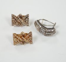 A pair of yellow metal and diamond chip cluster set earrings, of stylised bow form, 19mm and one