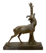 A 1930's French bronzed spelter model of a stag rubbing against a tree trunk, signed Cham, on