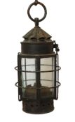 An early 20th century English black painted metal spirit fired lantern, height 38cm