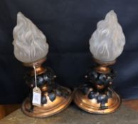 A pair of French Arts & Crafts copper and wrought iron ceiling lights with flambeau frosted glass