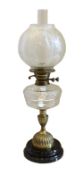 An Edwardian brass mounted cut glass oil lamp with etched glass globular shade, overall height