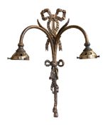 A set of three early 20th century English cast brass wall lights with ribbon tied foliate scroll