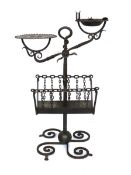 An early 20th century Arts & Crafts wrought iron smoker's stand, in the manner of Edgar Brandt,