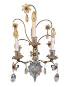 An early 20th century French wrought iron and cut glass three branch wall light with cut and