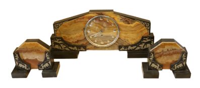 A French Art Deco coloured marble three piece clock garniture, carved with grazing deer, clock width