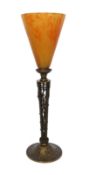 An early 20th century French bronze table lamp attributed to Daum, with pate de verre orange glass