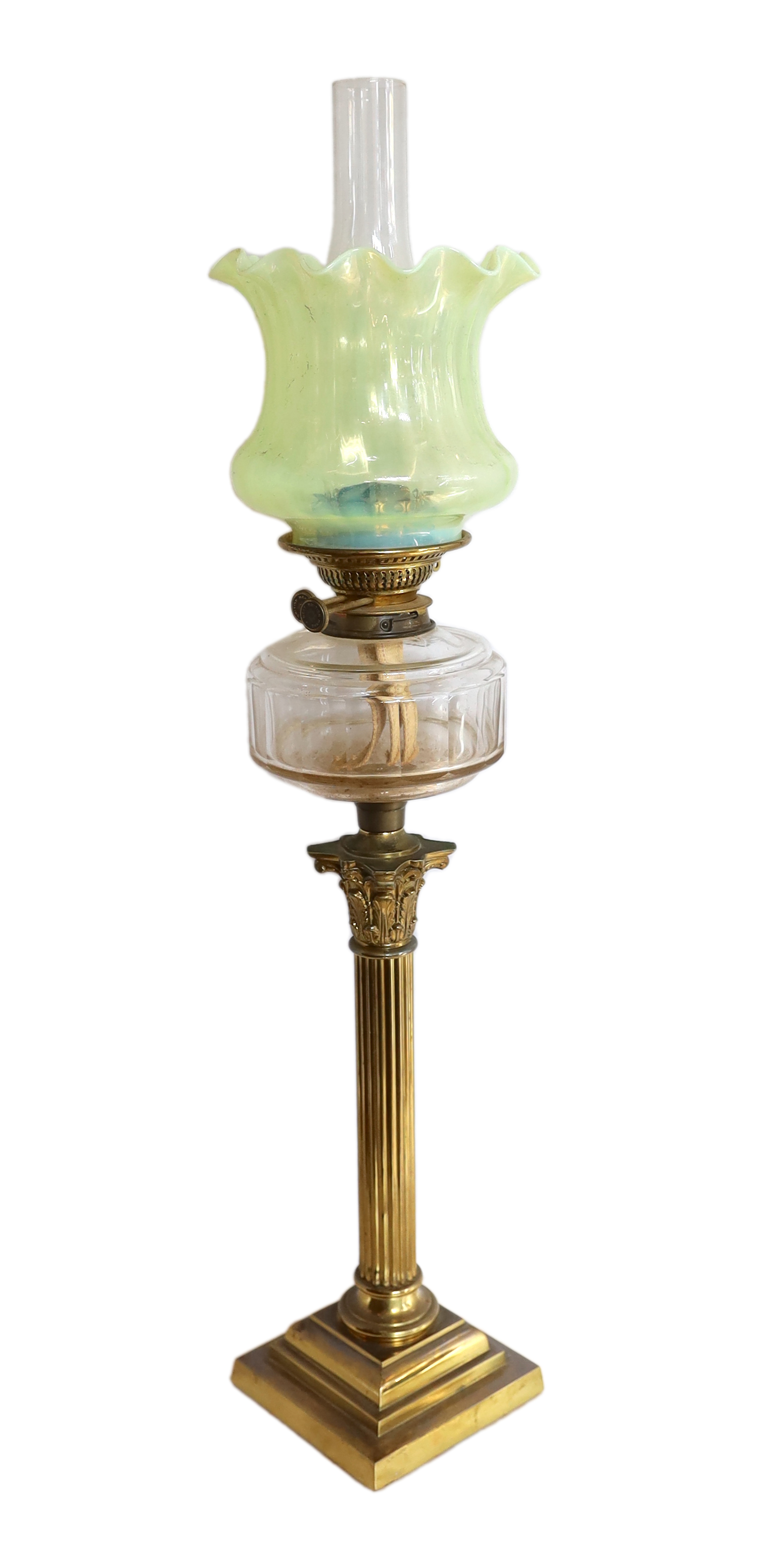 A Victorian brass corinthian column oil lamp with cut glass reservoir and vaseline glass shade,