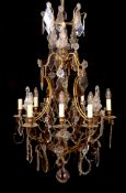 An early 20th century French gilt bronze and cut glass eight light chandelier profusely hung with