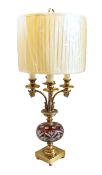 A 20th century Continental lacquered brass and Bohemian ruby overlaid glass table lamp with four