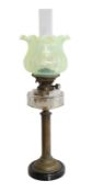 A Victorian brass oil lamp with clear glass reservoir and Hinks No.2 duplex mechanism, with vaseline