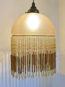 An opaque glass ceiling light with beaded fringe, 35 x 23cm
