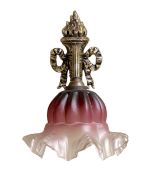 A 1930's French gilt brass wall light with torchere backplate and ruby tinted frosted glass shade,