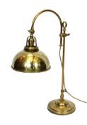 An early 20th century style brass adjustable desk lamp with solid shade, height 52cm