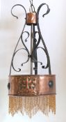 A Scottish Arts & Crafts wrought iron and copper light fitting designed by McKay Hugh Baillie Scott,