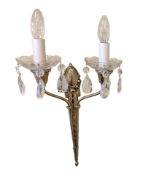 A pair of 1920's French brass twin branch wall lights, with cut glass sconces and facetted drops,
