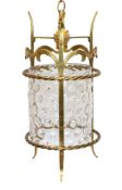 An early 20th century English Arts & Crafts brass hall lantern with stippled clear glass liner,
