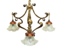 An early 20th century English Arts & Crafts brass light fitting of Art Nouveau scrolling form with