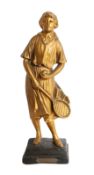 An early 20th century French gold painted plaster figure of a lady tennis player, with titled