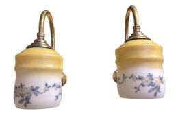 A pair of early 20th century English brass gas wall lights, converted to electricity, with opaque