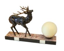 A 1930's French bronzed spelter and marble table lamp modelled with a stag beside a spherical