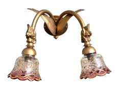 A pair of early 20th century gilt spelter two branch wall lights with Czechoslovakian lustre glass
