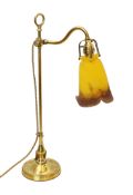 A 1920's French brass adjustable desk lamp with pate de verre glass shade, signed Muller Fréres,
