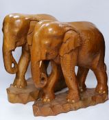 A pair of carved elephants, 42cm high