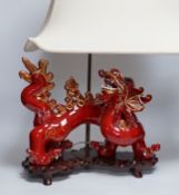 A modern Chinese red and gilt glazed ceramic 'dragon' table lamp on carved wood stand with shade,
