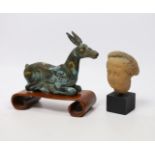 A Chinese bronze and parcel gilt Han style figure of a seated deer, and a small Etruscan
