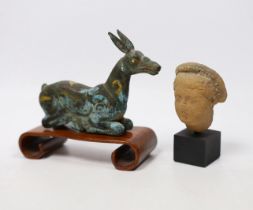 A Chinese bronze and parcel gilt Han style figure of a seated deer, and a small Etruscan