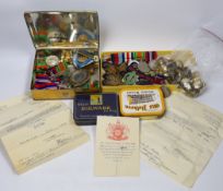A collection of mostly unnamed WWI and WWII medals, cap badges and buttons, one pair named 24835
