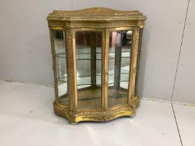 A Victorian giltwood and composition glazed serpentine side cabinet, width 92cm, depth 33cm,