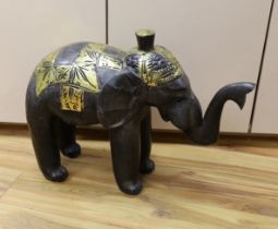 A carved Indian elephant, decorated with gilt decoration, 49cm high