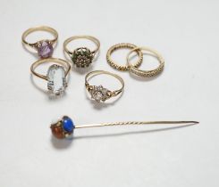 Four assorted modern 9ct and gem set rings including cubic zirconia, two other yellow metal and