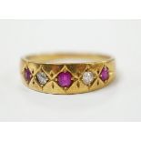 An early 20th century yellow metal ruby and diamond set five stone dress ring, size P