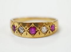 An early 20th century yellow metal ruby and diamond set five stone dress ring, size P
