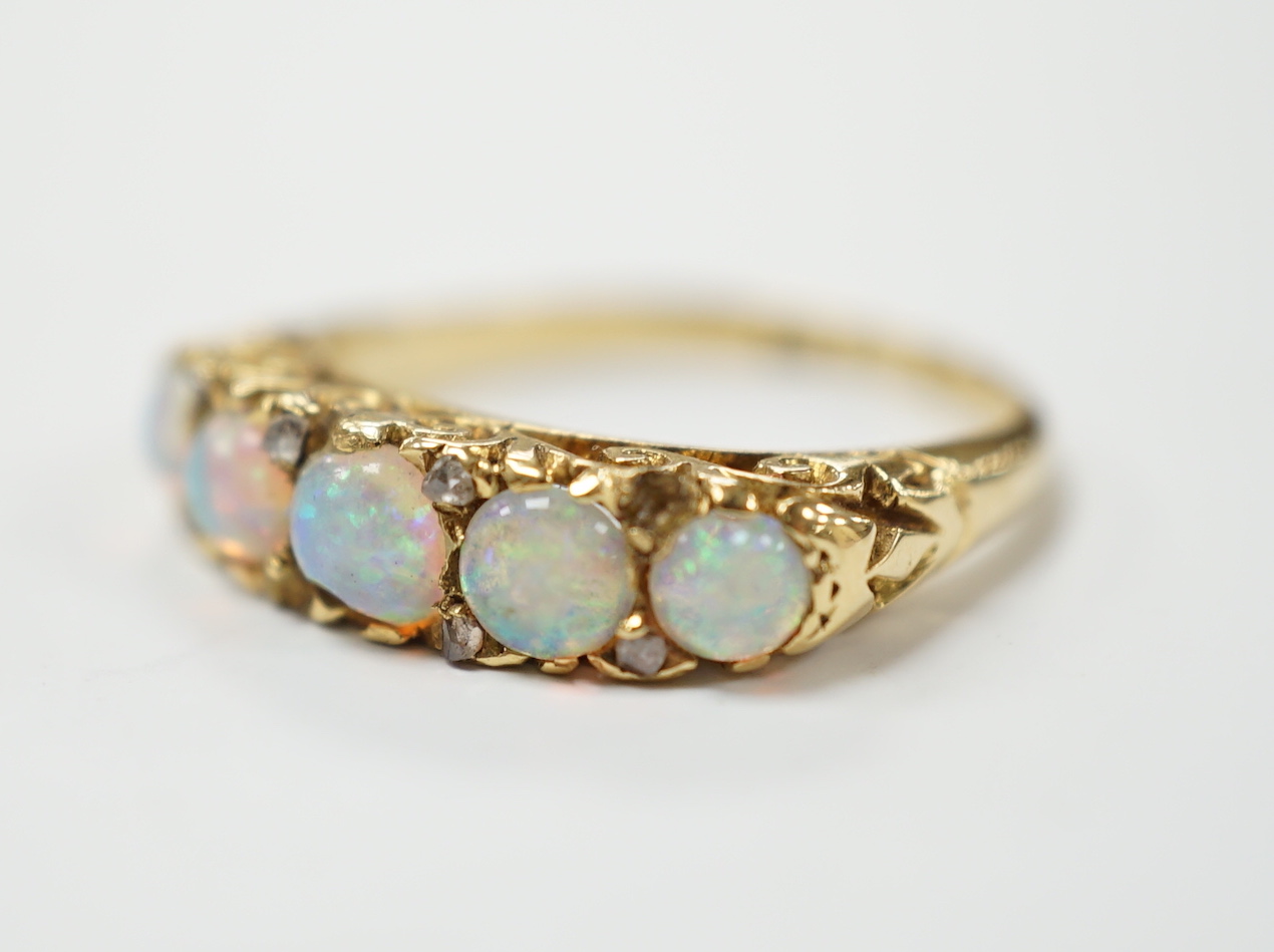 A late Victorian yellow metal and white opal five stone ring with diamond chip set spacers, size M - Image 2 of 4