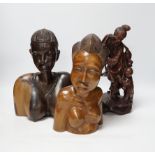 A Chinese carved rootwood figure emblematic of longevity on stand and two carved African busts,